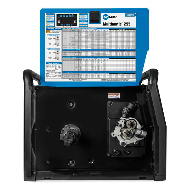 internal view of miller multimatic 255 welder showing drive rolls and parameters chart
