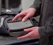 a man installing a replacement filter in to a miller papr blower unit