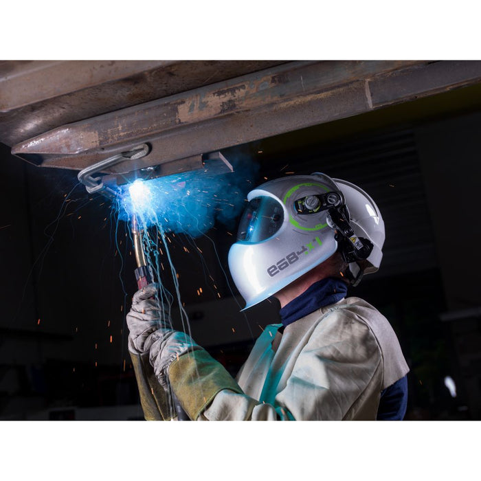action shot of man mig welding while wearing optrel e684 welding helmet