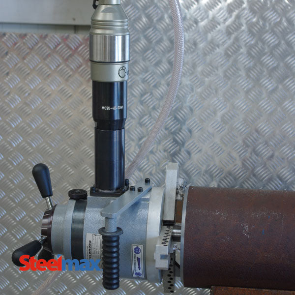Steelmax PB10 portable pipe beveling machine set up on pipe with hose