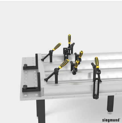 multiple pipe clamps holding a weldement in place on a siegmund welding table